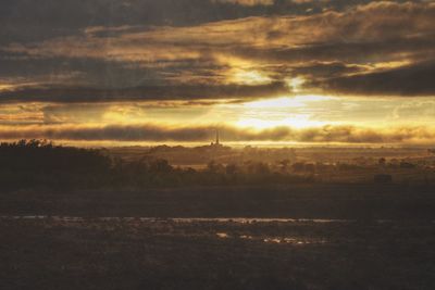 Scenic view of landscape against sky at sunset