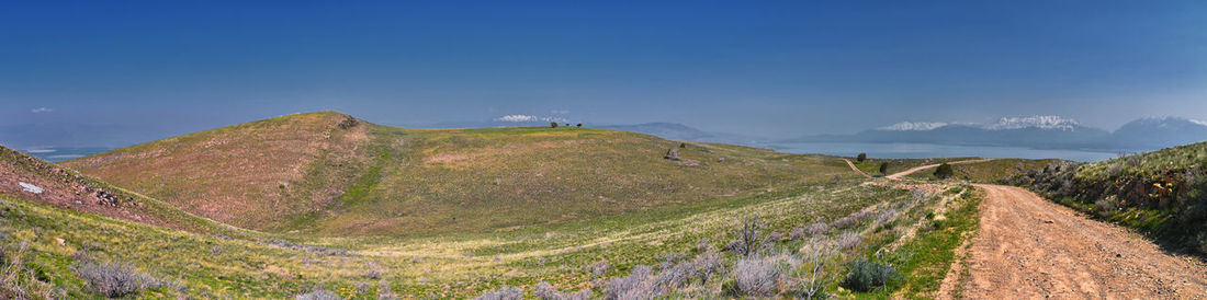 Scenic view of mountains against clear blue sky