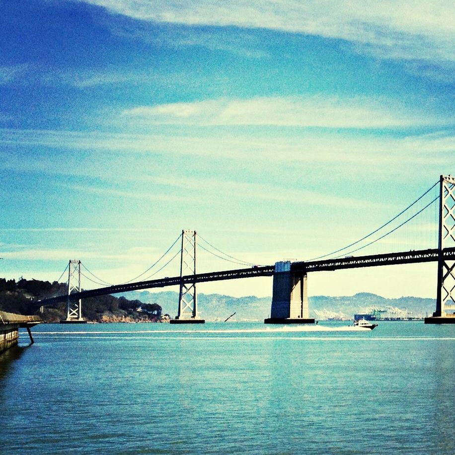 connection, bridge - man made structure, architecture, built structure, water, waterfront, transportation, sky, river, engineering, bridge, cloud - sky, suspension bridge, cloud, rippled, cloudy, city, sea, outdoors, no people