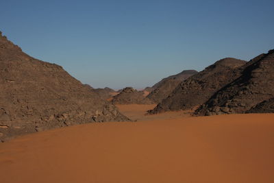 Scenic view of desert against clear sky acacus mountain, libya