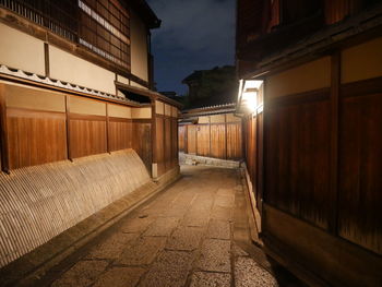 Empty street amidst buildings at night