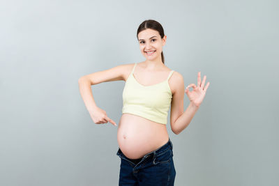 Portrait of a smiling young woman against white background