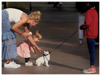 Rear view of women with dog