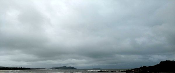 Scenic view of sea against storm clouds