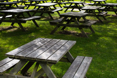 Empty bench on grassy field