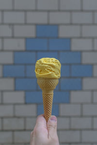  yellow colored  ice cream cone on a sunny day