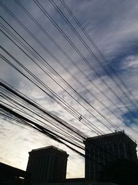 Low angle view of cables against sky