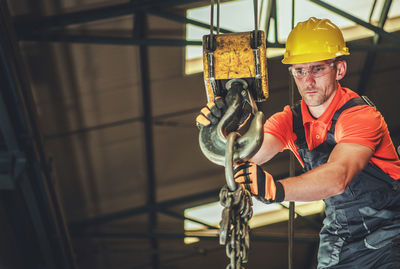 Low angle view of man welding metal