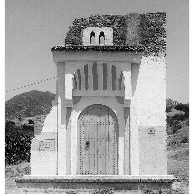 architecture, built structure, building exterior, arch, entrance, transfer print, history, architectural column, low angle view, day, gate, door, auto post production filter, building, sky, old, facade, outdoors, window, sunlight