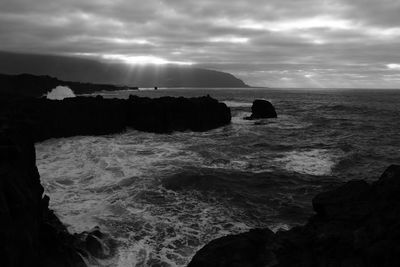 View of calm sea against cloudy sky