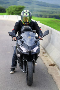 Man riding motorcycle on road