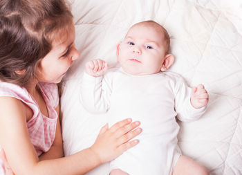 High angle view of cute baby lying on bed