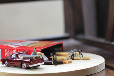 Close-up of male worker figurines with food on table