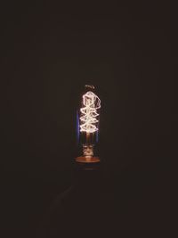 Illuminated light bulb in the dark