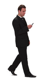 Young man using smart phone against white background