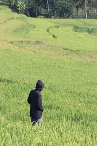 Rear view of man on field