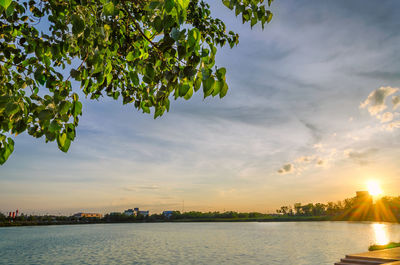 Scenic view of river against sky at sunset