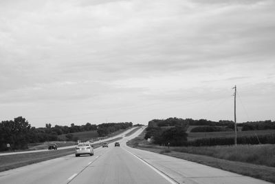 Cars on highway against sky