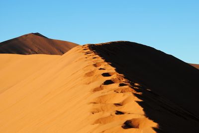 Scenic view of desert against clear sky