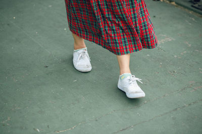 Low section of woman walking outdoors