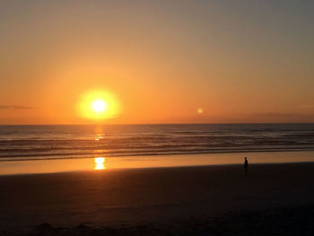 Scenic view of sea against clear sky during sunset