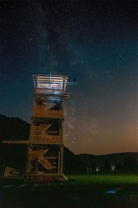 Low angle view of tower against sky at night