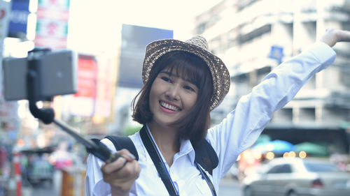 Portrait of smiling young woman wearing hat