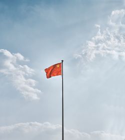 Low angle view of flag against sky