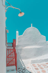 Whitewashed wall against clear blue sky