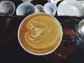 High angle view of cappuccino on table in cafe
