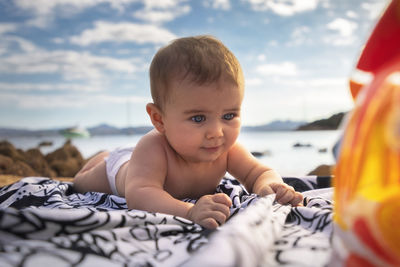 Portrait of cute baby at sea shore