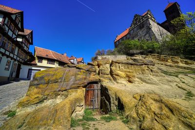 Low angle view of old building against clear blue sky