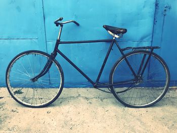 Bicycle parked against wall