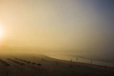 Scenic view of beach against sky during sunset