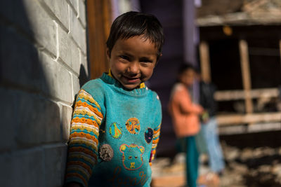 Portrait of boy standing outdoors