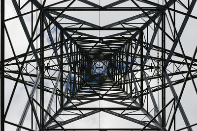 Dark abstract image of the inside of an electrical pylon. interior skyward view, looking up