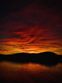 Scenic view of lake against romantic sky at sunset