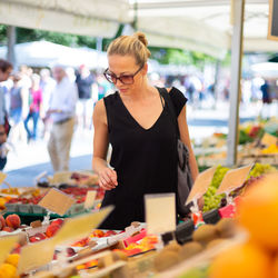 Woman standing at market stall