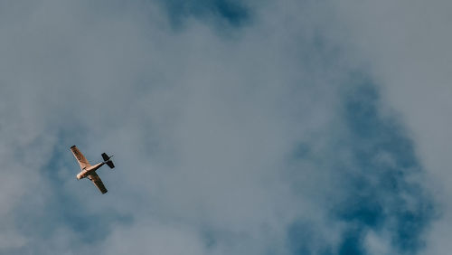 Low angle view of airplane flying in sky