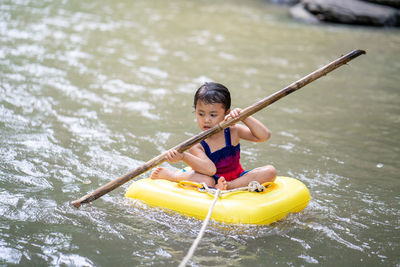 Active little girl playing at mountain stream