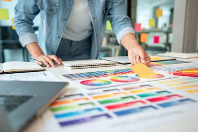 Midsection of business colleagues working at office