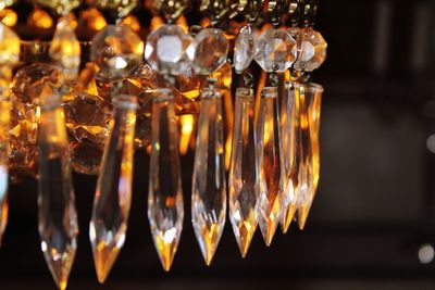 Close-up of illuminated candles in glass