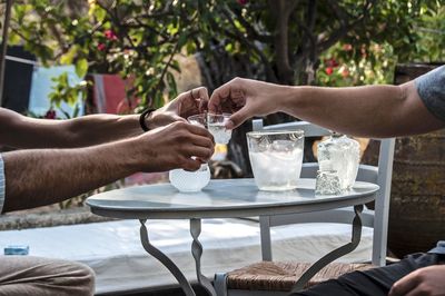 Mid section of men drinking outdoors