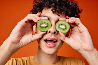 Portrait of smiling young woman holding fruits