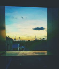 Residential buildings against cloudy sky at sunset