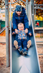 Sister with little brother on the slide