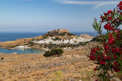 Scenic view at the city of lindos with white houses, the antique acropolis on top of the mountain