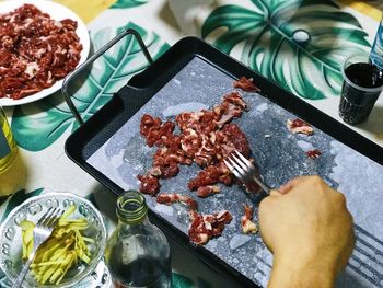 High angle view of person preparing food on table