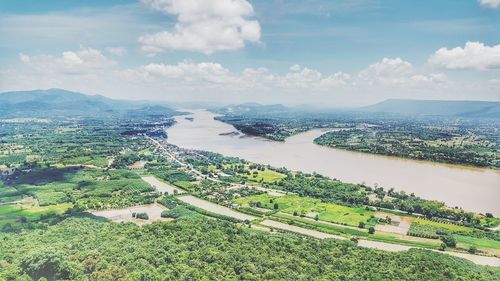 High angle view of river by agricultural field against sky