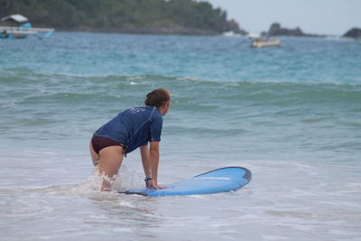 Rear view of boy in sea